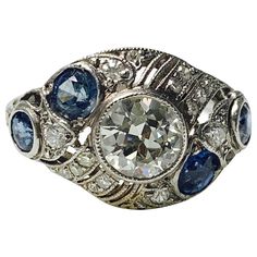 Antique old European cut diamond and blue sapphire ring handcrafted in platinum. The details are as follows : Diamond weight : 0.80 carat ( center ) ( H VS1) Diamond weight : 0.20 carat ( small diamonds ) ( HVS1 ) Blue sapphire weight : 0.60 carat Metal : Platinum Ring size : 5 3/4 Brilliant Cut Sapphire Diamond Ring In Platinum, Sapphire Diamond Ring With Brilliant Cut In Platinum, Platinum Sapphire Diamond Ring With Brilliant Cut, Art Deco Blue Diamond Ring, Blue Platinum Art Deco Diamond Ring, Blue Diamond Art Deco Ring, Blue Art Deco Diamond Ring, Classic Blue Diamond Ring With Single Cut, Art Deco Blue Diamond Ring With Rose Cut