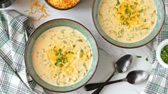 two bowls of soup with cheese on top