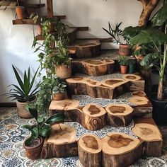 several pieces of wood sitting on top of a tiled floor next to potted plants