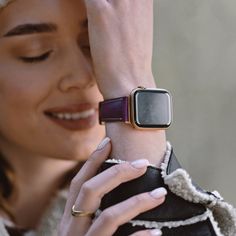 a woman holding her arm around an apple watch