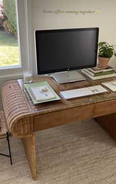 a desk with a computer monitor and keyboard on it