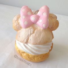 a close up of a pastry with a minnie mouse on it's face and a bow