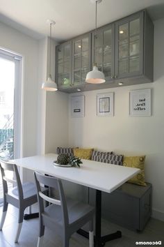 a white table and some chairs in a room