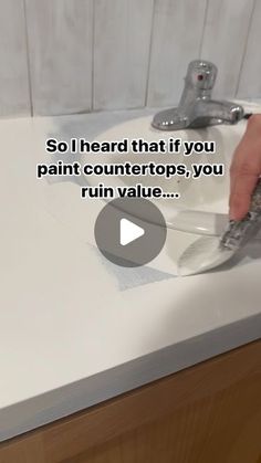 someone is using scissors to paint countertops in a bathroom sink with the caption, so i heard that if you paint countertops, you run value