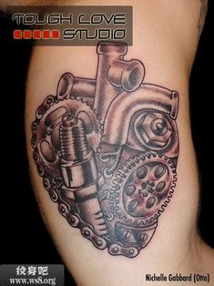 an image of a heart tattoo on the side of a woman's leg with gears