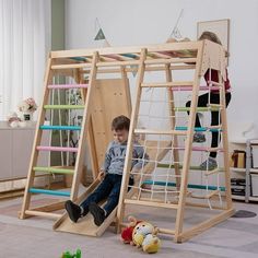 a young boy playing on a wooden swing set in a living room with other children's toys