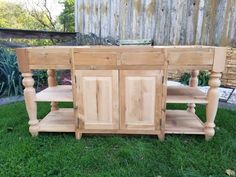 a kitchen island made out of wood sitting in the grass