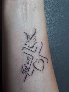 a tattoo on the arm of a person with a cross and doves in it