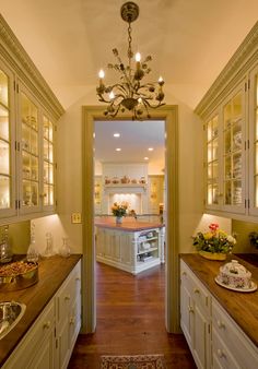 an open door leading to a kitchen with lots of counter space and cabinets in it