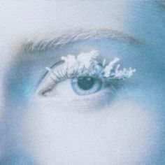 a woman's eye with snow on her eyelashes