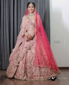 a woman in a pink and red bridal gown