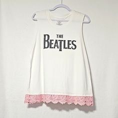 "The Beatles" Graphic Sleeveless Tshirt With A Gorgeous Lace Lining On The Bottom Hem. Size: Xl Color: White White Cotton Muscle Tee With Letter Print, White Letter Print Muscle Tank Tee, White Tank Tee With Letter Print, White Muscle Tee With Letter Print, Spring Sleeveless Band Merch Tops, Spring Band Merch Cotton Tank Top, Spring Cotton Tank Top With Band Merch, Beatles Graphic, Graphic Top