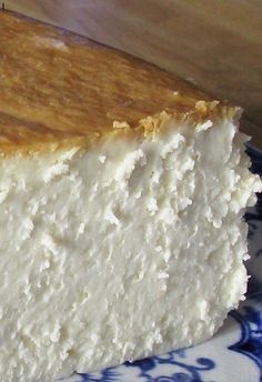 a piece of cheesecake sitting on top of a blue and white plate