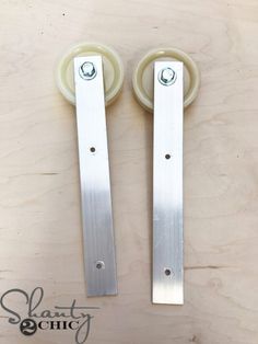 two sliding interior door handles on a wooden surface with text describing how to install them