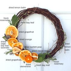 a grapefruit wreath with dried oranges and herbs on it, labeled in words