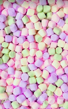 colorful marshmallows are scattered on top of each other