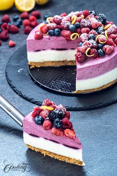 two slices of cheesecake with berries and raspberries on top