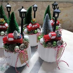 christmas decorations in white ceramic pots on a table