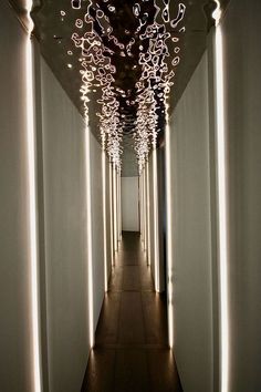 a long hallway with lights on the ceiling