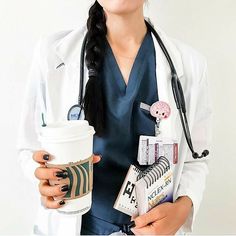 a female doctor holding a cup of coffee