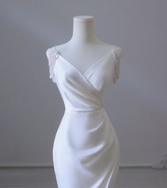 a white wedding dress on a mannequin