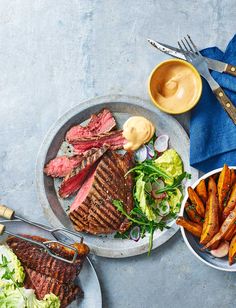 steak, lettuce and sweet potato wedges on a plate with dipping sauce