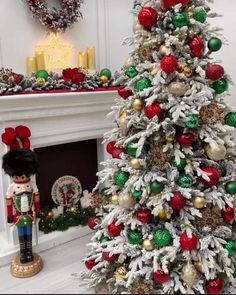 a christmas tree decorated with red, green and gold ornaments next to a fire place