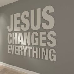 the words jesus changes everything are displayed on a wall in an empty room with hardwood floors