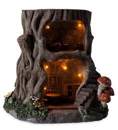 a tree stump house with lights inside