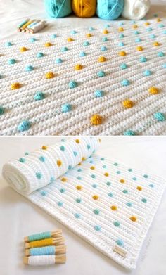 crocheted blanket with yarn and knitting needles next to ball of yarn on bed