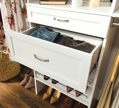 an open drawer in a closet filled with shoes