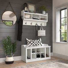 a white bench sitting under a window next to a potted plant