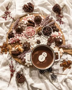 a platter filled with hot chocolate, marshmallows and other holiday treats