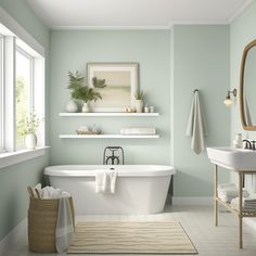 a white bath tub sitting next to a sink under a mirror in a bathroom with green walls