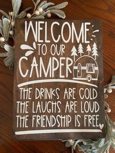 a wooden sign that reads welcome to our camper the drinks are cold and the laughs are loud the friends is free