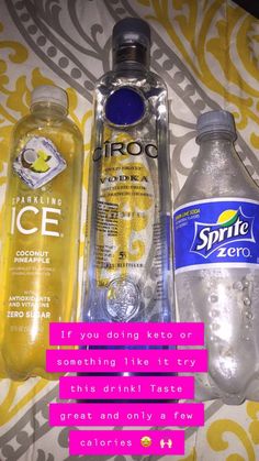 two bottles of water and one bottle of ice on a bed with yellow and pink wallpaper