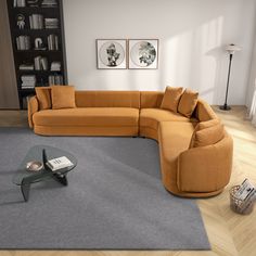 a living room with a large sectional couch and coffee table in the middle, surrounded by bookshelves