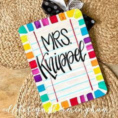 a paper tag with the words mrs klippef on it and a bow