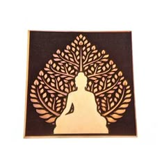 a wooden cutout of a buddha sitting in front of a tree with leaves on it