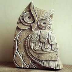 an owl statue sitting on top of a wooden table