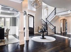 a living room filled with furniture and a staircase