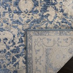 two pieces of blue and white rugs on top of each other with different patterns