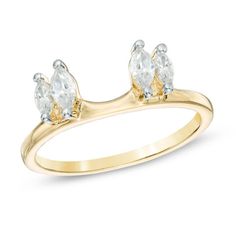 a yellow gold ring with three pear shaped diamonds