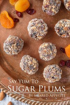 an image of sugar plums on a plate with nuts and dried apricots