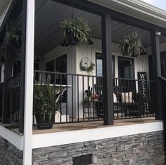 the front porch is decorated with potted plants