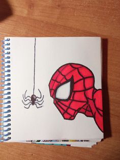 a drawing of a spider - man hanging from a web on a white sheet of paper