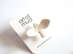 a white brochure with the word art of mud on it's side