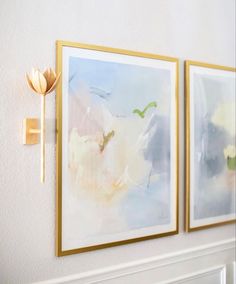 two paintings are hanging on the wall next to each other, one has a gold flower