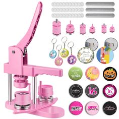 a pink sewing machine with lots of buttons and magnets on the front, along with other items