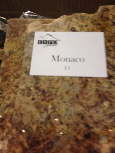 there is a sign on the marble counter top that says monaco 11 in spanish and english